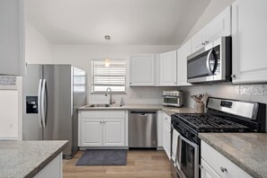 Een microgolfoven, een oven, een kookplaat, een vaatwasser