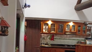 A compact kitchen with wooden cabinets and a built-in microwave.