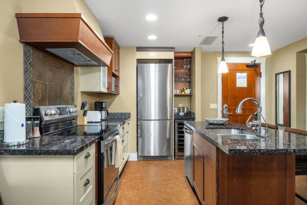 Fridge, toaster, cookware/dishes/utensils, dining tables