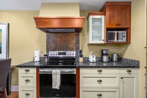 Fridge, toaster, cookware/dishes/utensils, dining tables