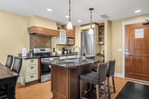 Fridge, toaster, cookware/dishes/utensils, dining tables