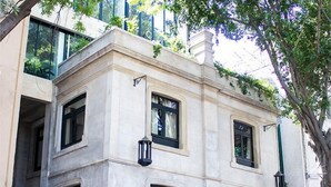 A corner building with a stone facade, multiple windows, and a black wrought iron gate. - Modern Suite 3 - Heart of Roma Norte (Mexico City)