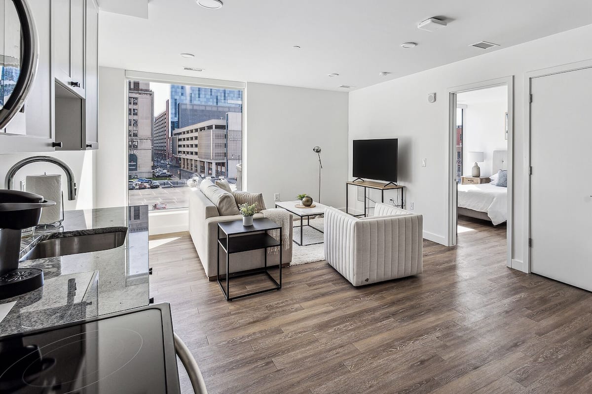 A modern living room with a sofa, coffee table, and TV.