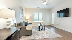 Apartment, 1 Bedroom | Living area | 50-inch TV with digital channels