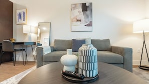 Apartment, 1 Bedroom | Living area | 50-inch TV with digital channels