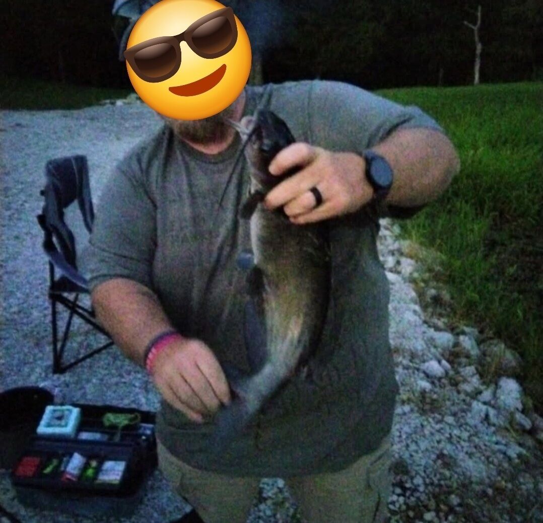 A person holding a fish.