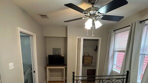 A bedroom with a bed, a ceiling fan, a desk with a television, and a closet. - Fully furnished. we provide all utilities wifi and gated parking. pet friendly (New Orleans)