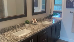 A bathroom with two sinks, dark cabinets, and a large mirror. - Valle verde get-away in upscale neiborhood! (Poway)