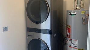 A compact utility room with a double-washer unit and a water heater. - Valle verde get-away in upscale neiborhood! (Poway)