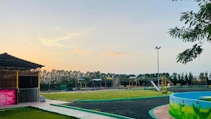 A playground with a slide, swings, and a fenced area. - The Aurum Zurich Club Kalaburgi (Gulbarga)