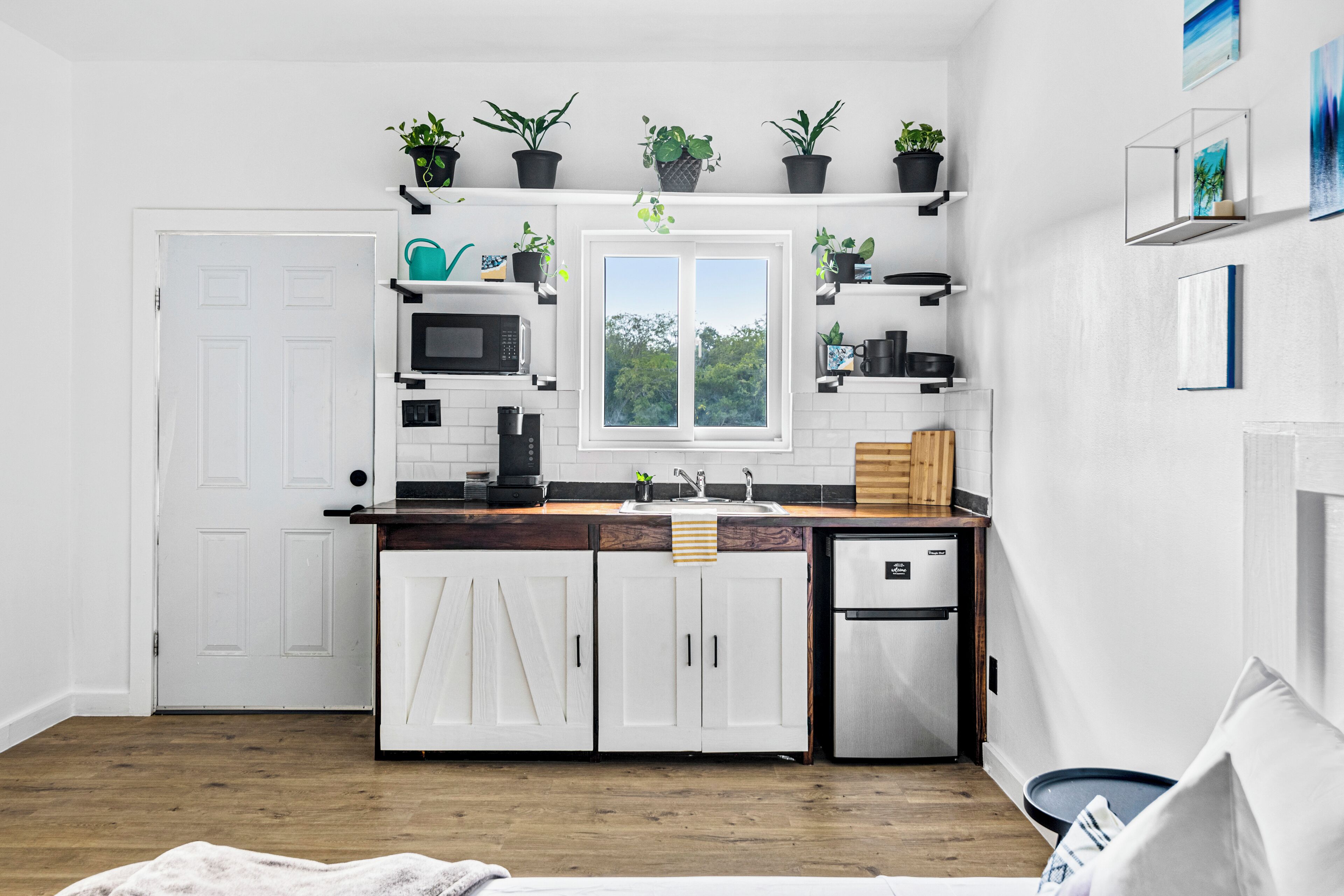 Fridge, microwave, coffee/tea maker, cookware/dishes/utensils