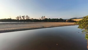 A calm river with a bridge in the background. - Qurata Riverside Resort (Kuala Terengganu)