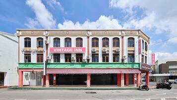 A building with a sign reading 'VINTAGE INN' and a storefront with closed shutters.