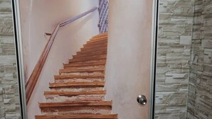 A staircase with wooden steps leading to a landing with a metal railing. - Vintage Inn Jonker Walk Melaka (Malacca City)