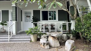 A house with a porch, steps, and potted plants. - Bann Kam B&B (Krabi)