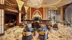 A spacious lobby with a chandelier, seating area, and a 'CHAMPION' sign. - Champton Nha Trang (Nha Trang)