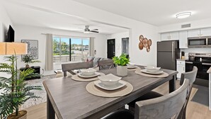 A modern kitchen with white cabinets, a microwave, and a refrigerator. - Charming 1BR Getaway with King Bed in Royal Oak (Royal Oak)