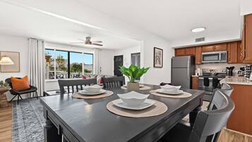Enjoy meals with a view in this open-concept kitchen and dining area, flowing seamlessly into the bright and cozy living room.