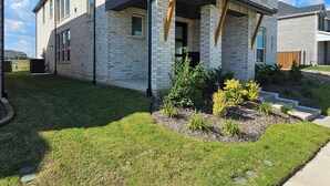 A modern two-story house with a brick facade, large windows, and a well-maintained lawn. - Spacious 5-bedroom house with WiFi, AC in brilliant Mesquite (Mesquite)