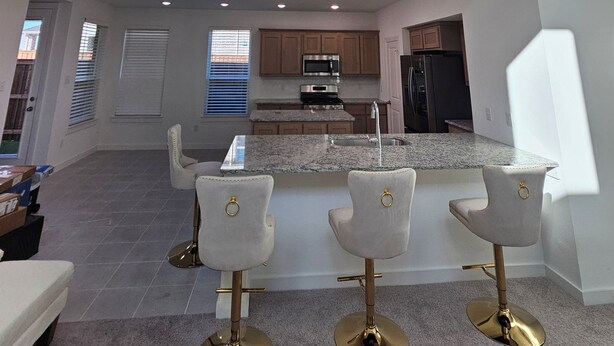 A spacious kitchen with a high ceiling, a central island, and bar stools. - Spacious 5-bedroom house with WiFi, AC in brilliant Mesquite (Mesquite)