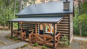 A rustic log cabin with a porch and a stone fireplace. - Welcome to Tangled Up Cabin! A Luxury Adults Only HotTub/Sauna Playroom (Blue Ridge)
