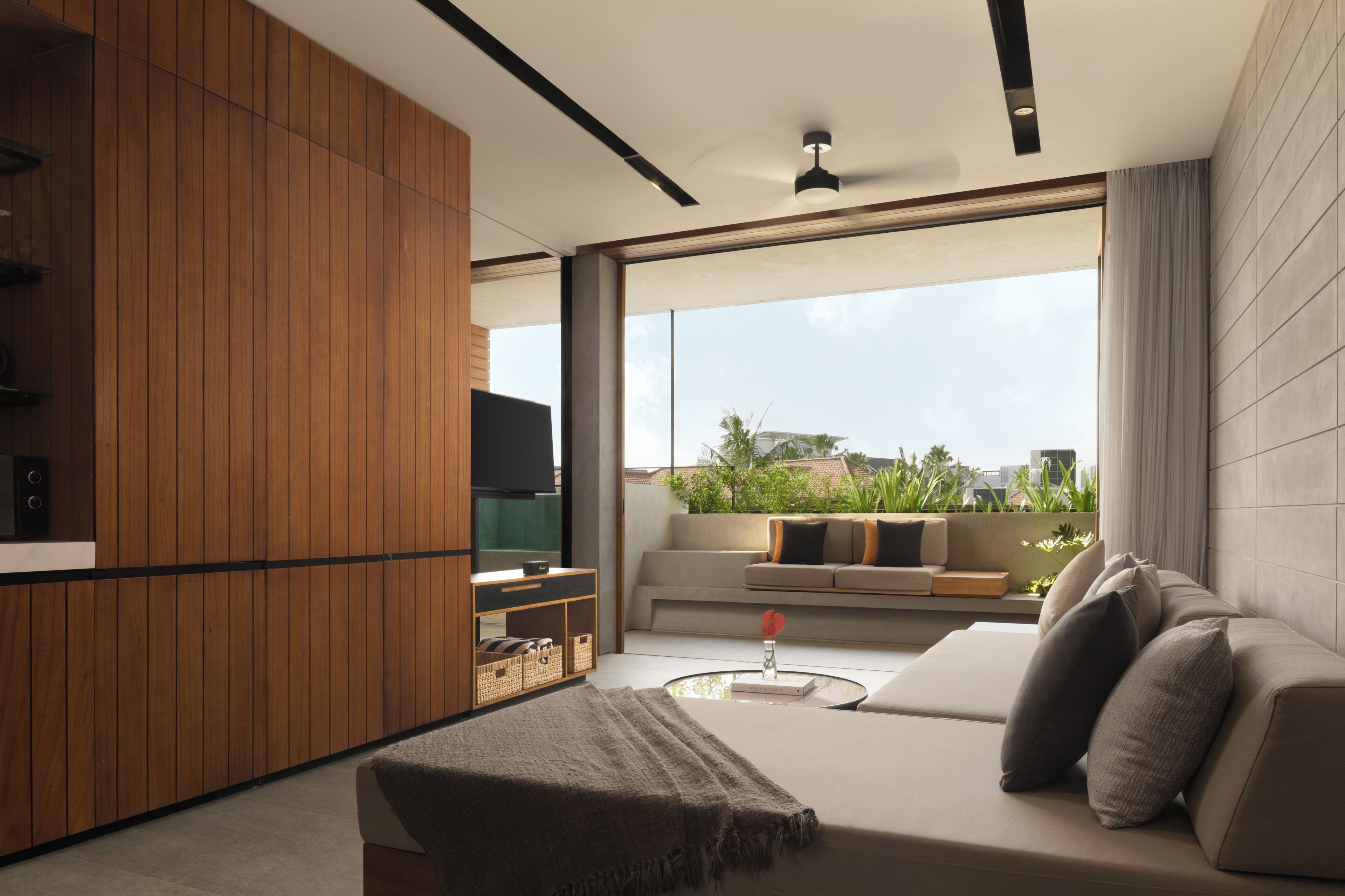 A modern living room with a sofa, a coffee table, and a television.