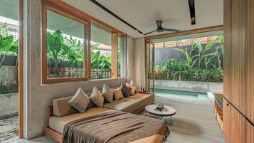 One-Bedroom Deluxe Apartment with Garden | Living area | Flat-screen TV