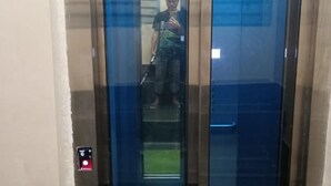 An elevator with glass doors and a visible emergency button. - Qish Hotel (Malacca City)