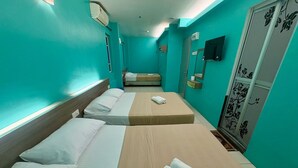 A hotel room with two beds, a small sitting area, a mirror, and a wardrobe. - Qish Hotel (Malacca City)