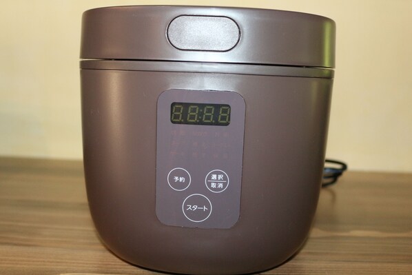 A brown rice cooker with a digital display and control buttons.