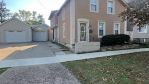 A residential house with a garage, a front yard, and a driveway.