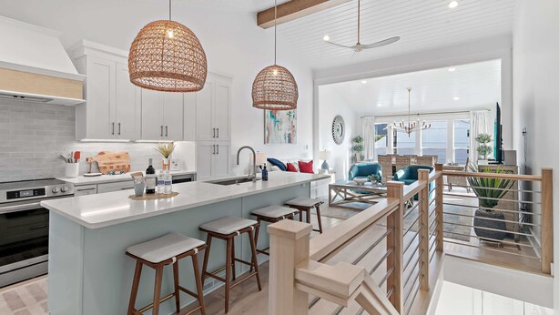 A modern kitchen with white cabinetry, a central island with stools, and pendant lighting. - Steps to the Private Beach, BRAND NEW renovations, 3 Bikes - 30A Sun Joy (Santa rosa beach)