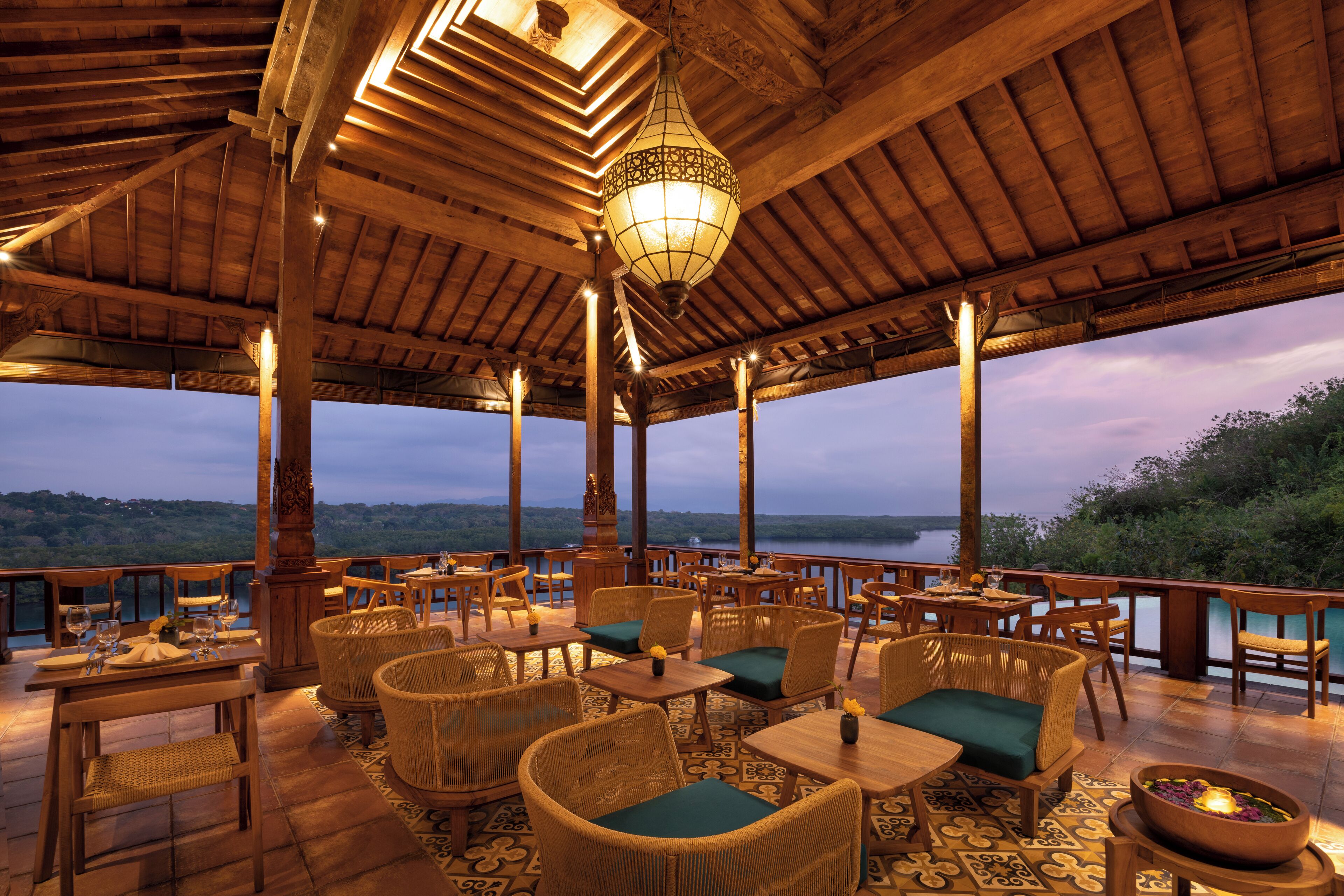 An outdoor seating area with wicker furniture and a view of the landscape.