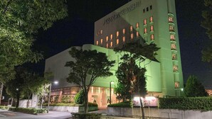A hotel with a green facade, multiple windows, and a well-lit entrance. - Palace Hotel KAKEGAWA (Kakegawa)