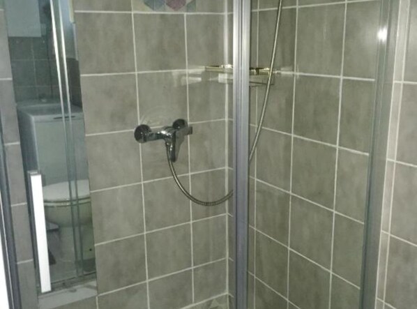 A shower area with a glass door, tiled walls, and a handheld showerhead. - Beach House - 2m From Beach (Starigrad)