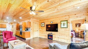A wooden cabin interior with a living room, kitchen, and dining area. - 18 Mi to Red River Gorge: Beattyville Retreat (Beattyville)