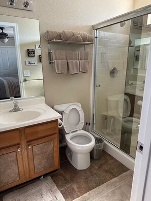 Shower, hair dryer, towels, toilet paper