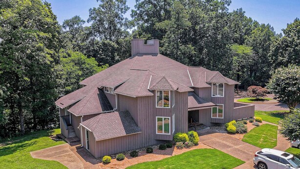 A two-story house with a sloped roof, a front porch, and a driveway. - Resort Condo w/ Marina Access in Williamsburg! (Williamsburg)