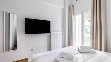 Apartment, 1 Bedroom, Kitchen, City View | Desk, laptop workspace, blackout drapes, iron/ironing board