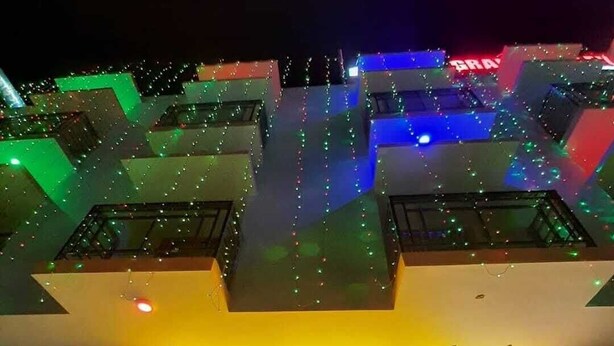 The exterior of Hotel Grand Valley with a prominent entrance and a motorcycle parked outside. - Hotel Grand Valley (Bandarban)