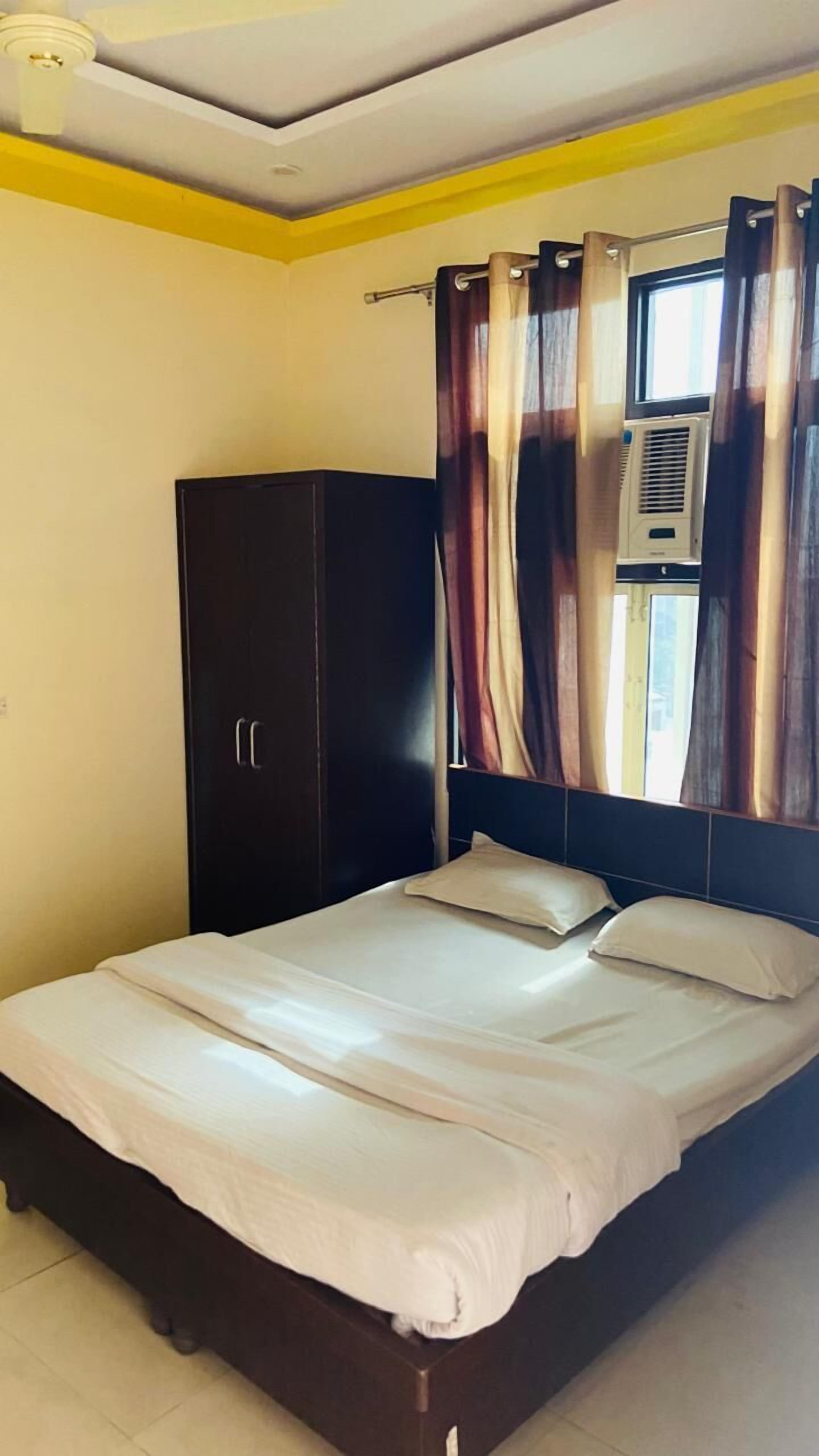 Una camera da letto con un letto, un armadio e un condizionatore d'aria.