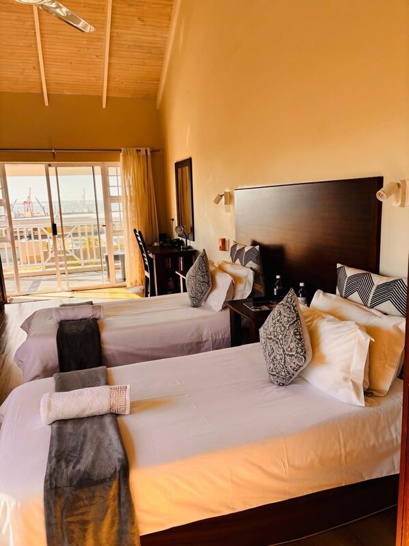 Deluxe Triple Room, Sea View | Individually decorated, individually furnished, desk, laptop workspace