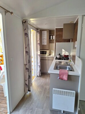 Fridge, microwave, coffee/tea maker, cookware/dishes/utensils