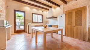 Una cocina con una mesa de madera, una ventana y una puerta.