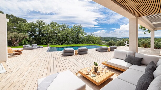 A spacious outdoor deck with a pool, surrounded by lush greenery and a clear sky. - CALIFORNIAN VILLA IN GATED COMMUNITY (OPIO)