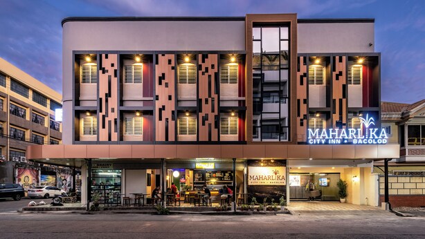 A modern building with a prominent sign for 'MAHARLIKA City Inn Bacolod'. - Maharlika City Inn  (Bacolod)