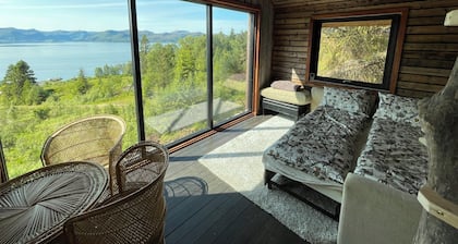 Stunning fiord panorama view off-grid forest cabin