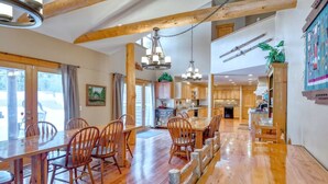 A spacious dining area with wooden furniture and a high ceiling with exposed beams. - Mountain Meadow Lodge • Dog-Friendly • Hot Tub (Frisco)