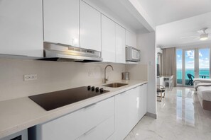 Fridge, microwave, coffee/tea maker, cookware/dishes/utensils