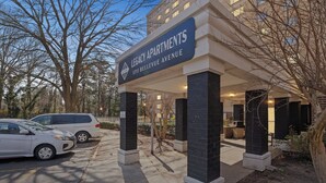 A building entrance with a sign reading "Legacy Apartments 1711 Bellevue Avenue."